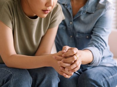 Middle aged asia people old mom holding hands trust comfort help young woman talk crying stress relief at home. Mum as friend love care hold hand adult child feel pain sad worry of life crisis issues.